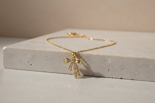The Gilded Ribbon Bow: 18k Gold Anti-Tarnish Necklace with Radiant Crystal Accents