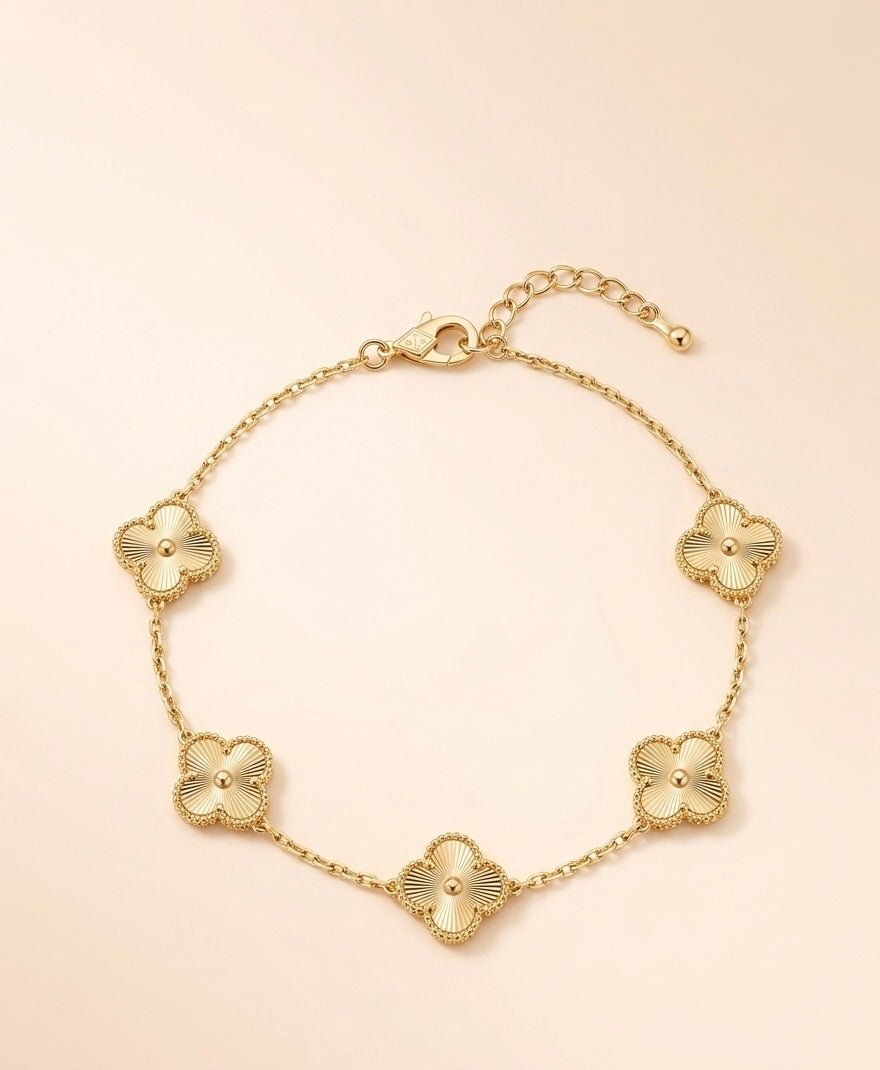 Radiant Clover Motif Bracelet: Timeless Elegance in Sunray-Etched Gold